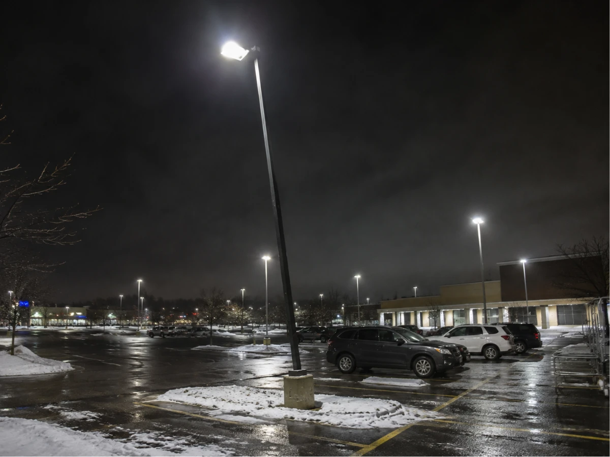 Image showing parking lot lighting pole leaning at an angle