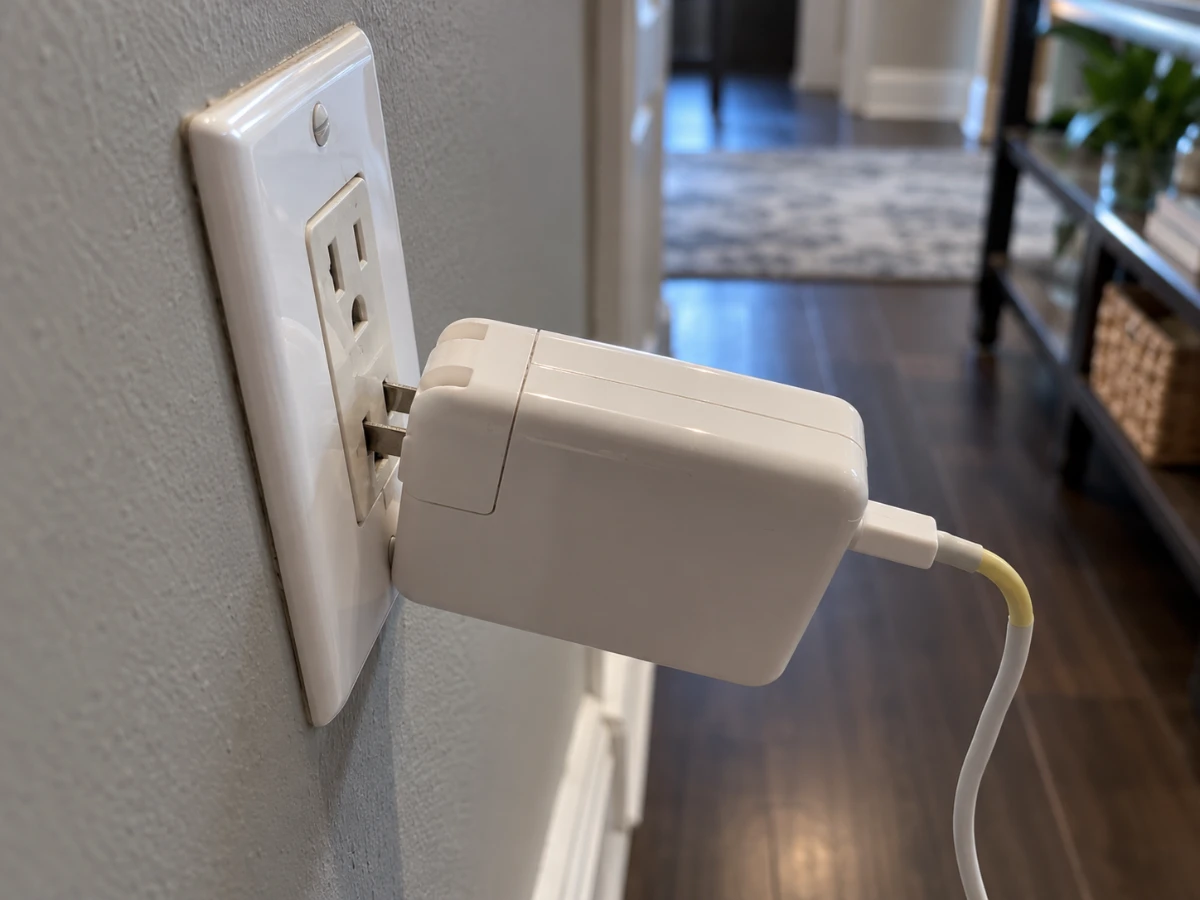 Image of a plug connected to a loose electrical outlet